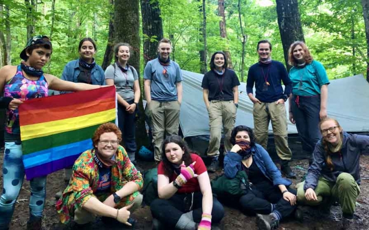 a group of teens pose for a photo at a campsite on an outward bound course for lgbtq teens